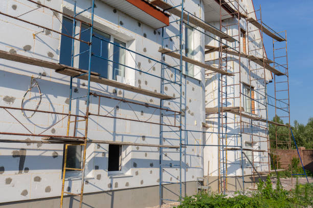 istock The process of building wall insulation using polystyrene in the open air. Scaffold on house, renovation. House for renovation with the scaffolding for workers on building 995914632