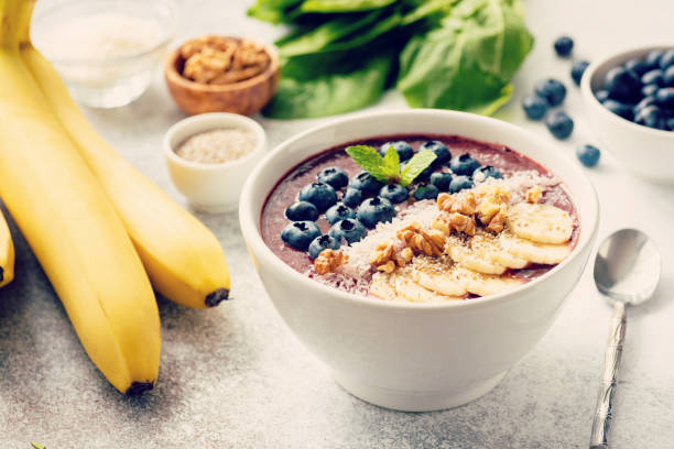istock Acai smoothie bowl on grey concrete background 995925872