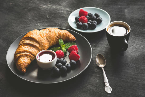 istock French croissant, berries, jam and coffee 995925982