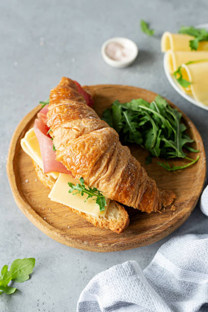 istock Tasty croissant sandwich with ham and cheese 995925998
