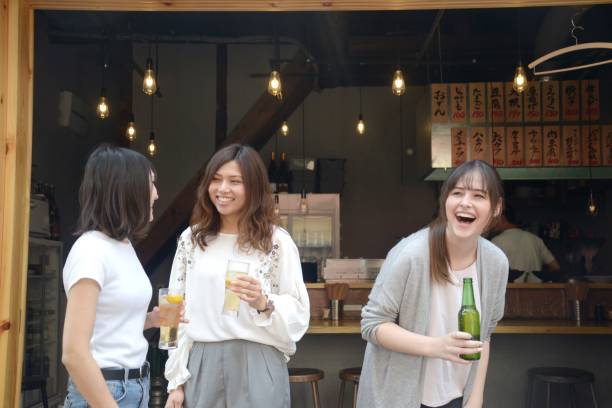 istock Various ethnic young people enjoying drinking together 995932628