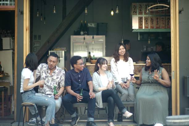 istock Various ethnic young people enjoying drinking together 995933128