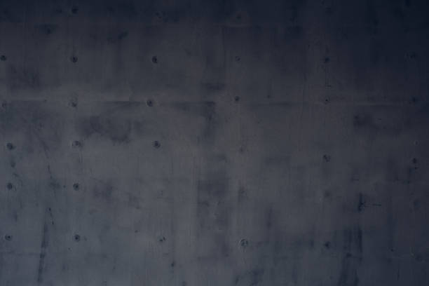 istock Dark gray rough surface of a concrete wall as a background texture 995940292