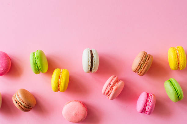 istock Colorful macarons cookies, top view flat lay, food background co 995949652