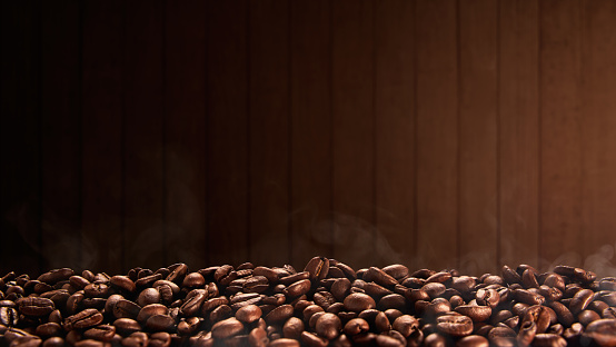 Roasted coffee beans with wooden background, copy space