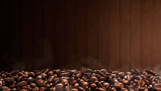 Roasted coffee beans with wooden background, copy space stock photo