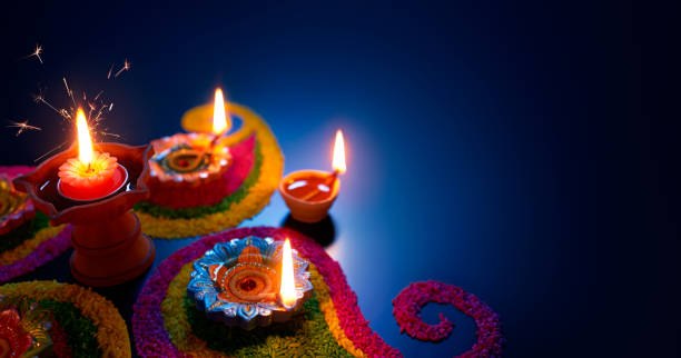 oil lamps lit on colorful rangoli during diwali celebration - tamil imagens e fotografias de stock