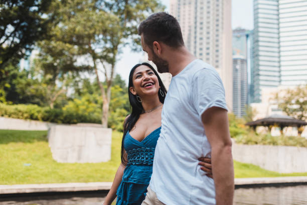 istock Couple walking in Kuala Lumpur and embracing each other 995955940