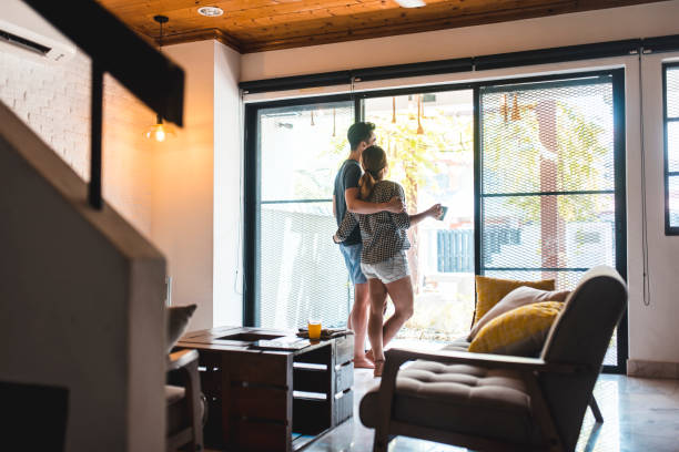 istock Chinese couple standing by the window with coffee 995962970