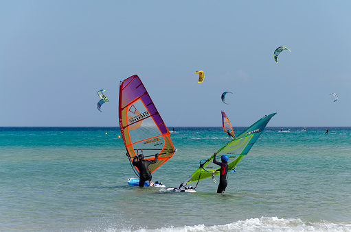 Sotavento beach, Fuerteventura, Canary Islands, Spain: May 26th, 2018. Windsurfers and kitesurfers from Rene Egli Windsurfing and Kitesurfing School training on Sotavento beach.
