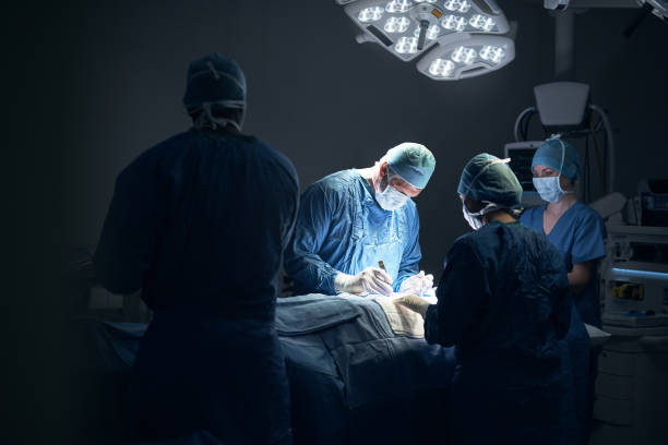 There is magic in the profession of saving lives Shot of a team of surgeons performing a surgery in an operating theatre operating room photos stock pictures, royalty-free photos & images