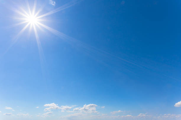 istock blue cloudy sky with sparkle sun, natural background 995967404