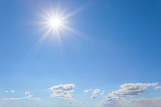 istock blue cloudy sky with sparkle sun, natural background 995967424