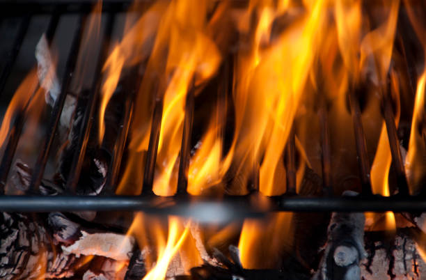 istock Black metal barbecue grill on fire 995996640