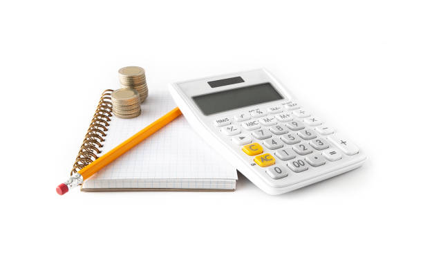 Calculator and pen on a wire bound notebook stock photo