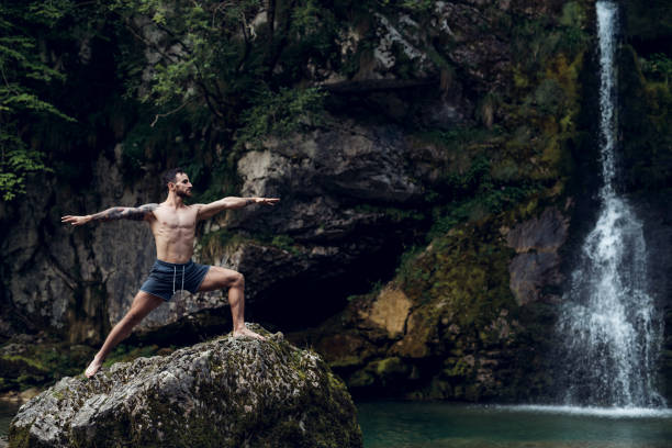 Yoga Man practicing yoga in nature man yoga tattoo stock pictures, royalty-free photos & images