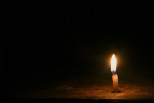 istock Candle light in the dark night 996002754