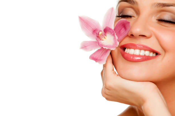 istock beautiful young woman hold a orchid on white background 996006008