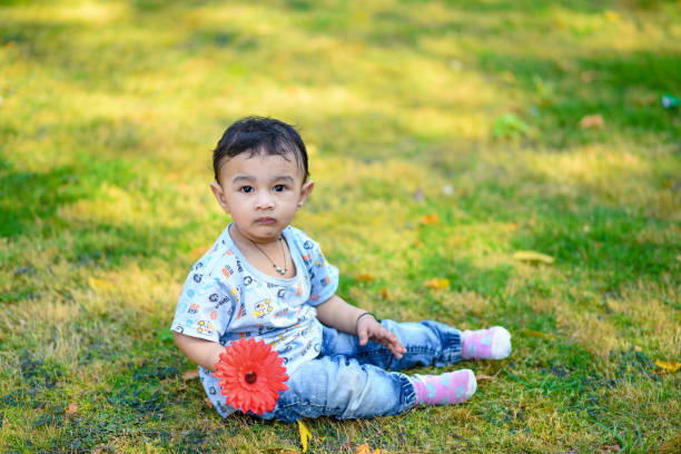 istock cute indian baby boy playing at garden 996007672