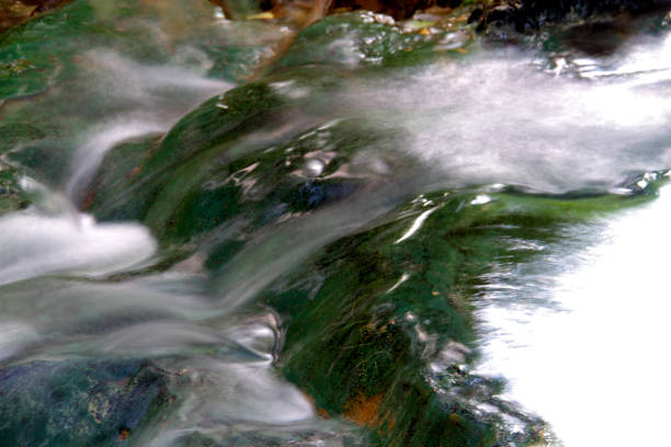Pristine waterfalls deep in the woods, on a bright sunny day in spring, in Transylvania