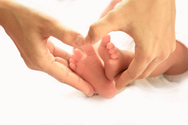 istock heart shape with the new born legs 996007902