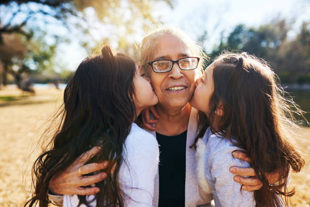 It's a blessing to have grandchildren Cropped shot of a grandmother getting kissed on the cheeks by her two adorable granddaughters sister photos stock pictures, royalty-free photos & images