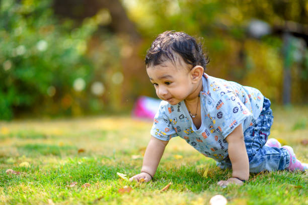 istock cute indian baby boy playing at garden 996012286