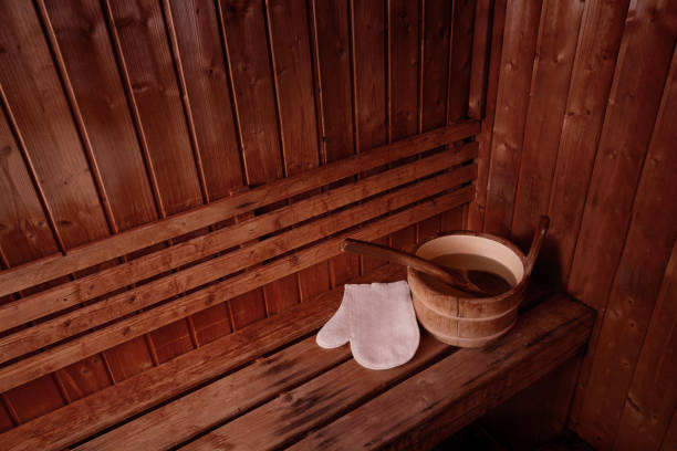 istock Sauna interior with bucket with water and white massage glove 996020666