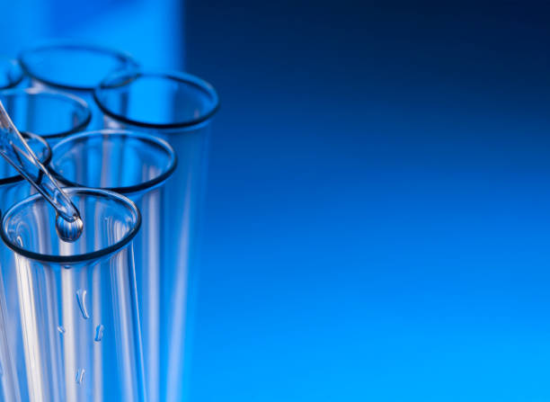 istock glass test tube with dropper on blue background with substance 996021520
