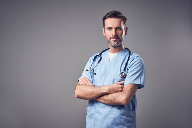 istock Doctor in blue uniform standing with crossed arms, isolated 996026896