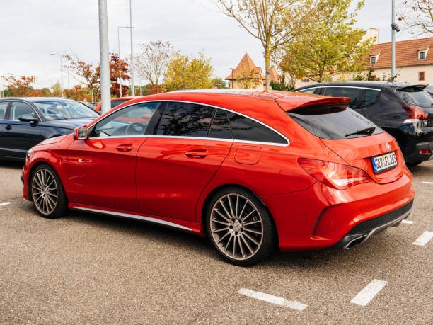 Red new Mercedes Benz car parked in city Augsburg: Rear side view of modern luxury red Mercedes Benz estate car parked in city mercedes argentina stock pictures, royalty-free photos & images