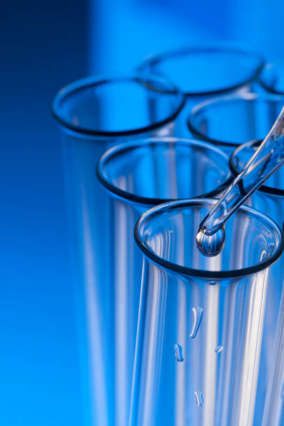 istock glass test tube with dropper on blue background with substance 996035034