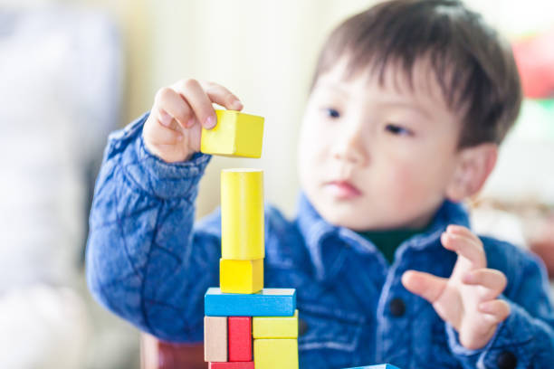 istock Little boy playing colorful wood blocks 996048862
