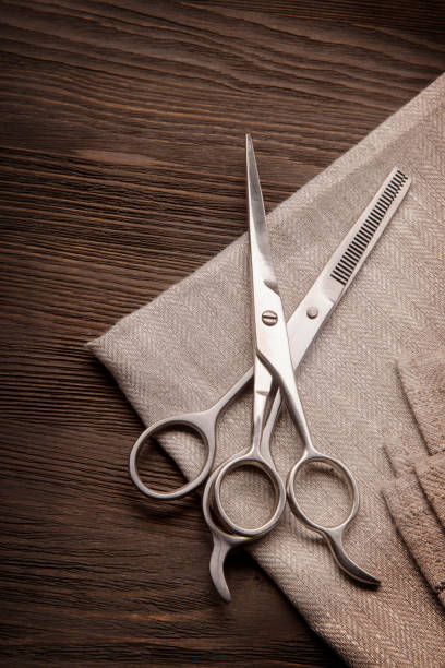 Hairdressing scissors on a black wood backgroundHairdressing scissors on a black wood background