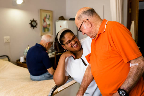 istock Senior man at nursing home laughing with the nurse 996054976