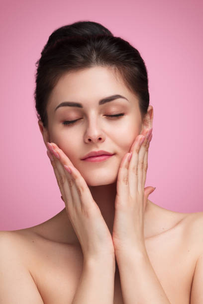 istock Pretty woman applying cream on cheeks 996055524