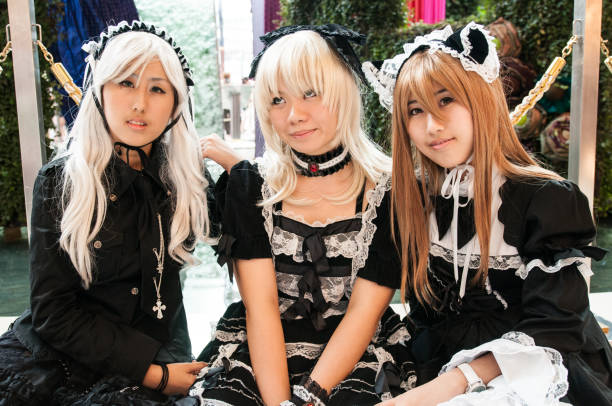 three young thai girl posing for a photogrpher during a cosplay festival in front of Siam Pagagon, Bangkok stock photo