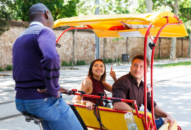 istock Couple riding around city on rickshaw 996074028