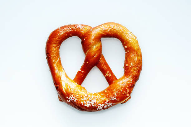 istock Delicious fresh salted pretzel on white background 996078356