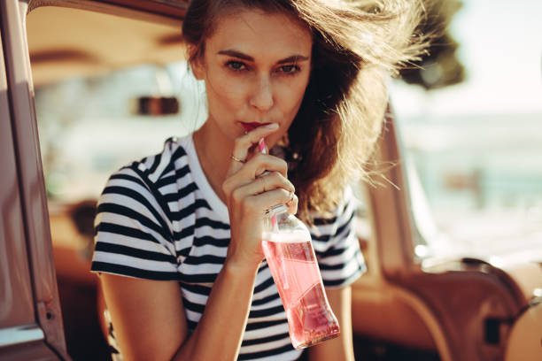 istock Woman drinking beverage on road trip 996078794