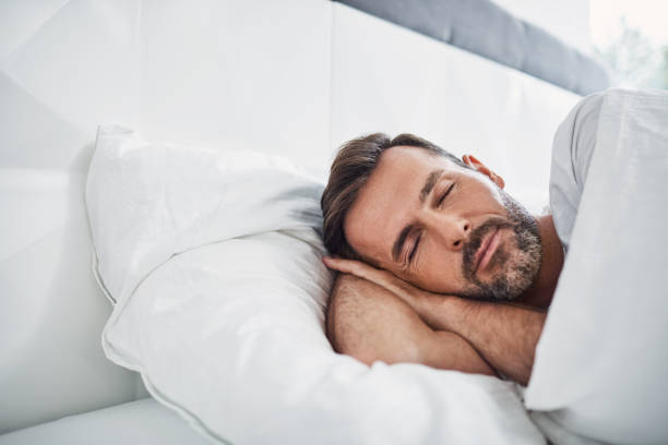 istock Handsome man sleeping in bed at home 996087798