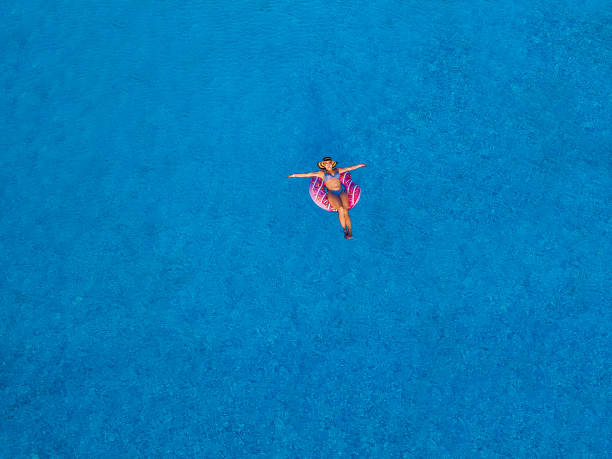 istock girl swimming pool 996091630