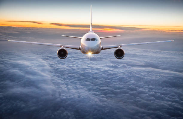 istock Commercial airplane flying above clouds 996092500