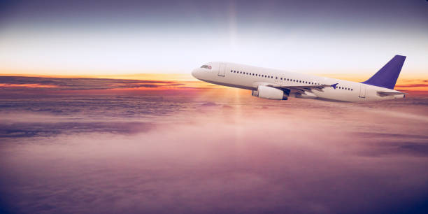 istock Commercial airplane flying above clouds 996093018
