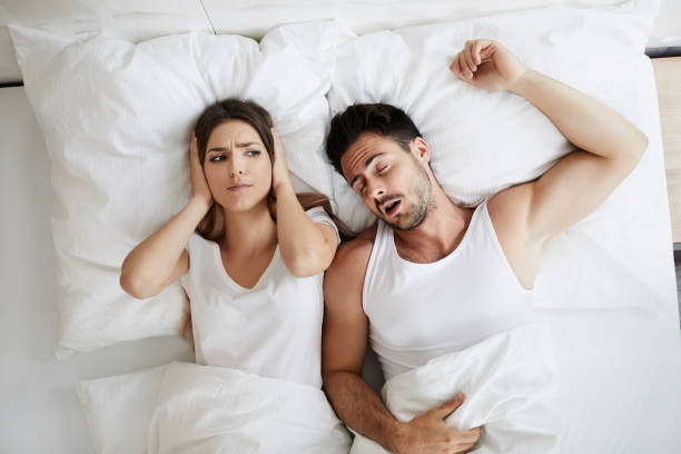 istock Stressed young woman covering her ears because her husband is snoring 996096184
