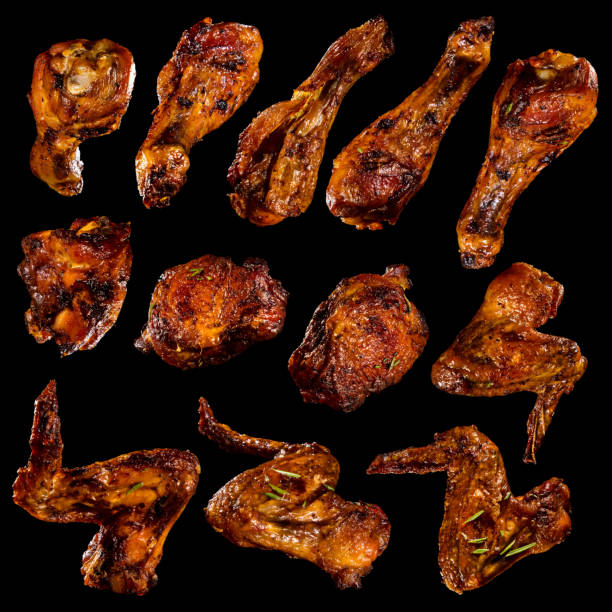 Chicken legs and wings collection isolated on black background.