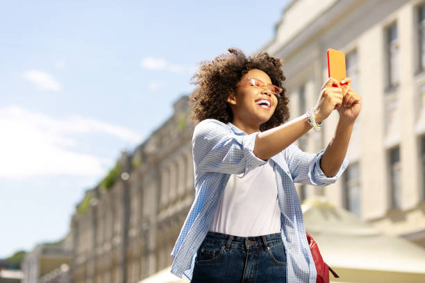 istock Charming young woman taking selfies during sightseeing 996096586