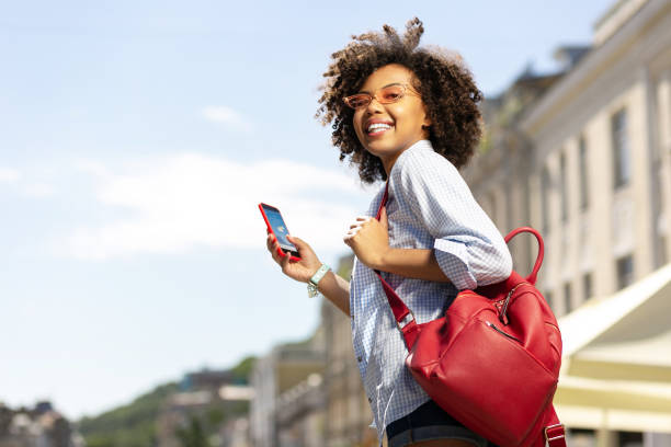 istock Upbeat curly woman checking weather forecast on phone 996096822