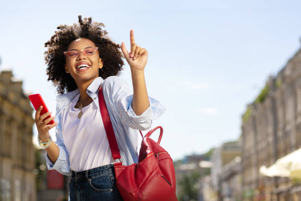 istock Pleasant curly woman asking to wait for one minute 996097108