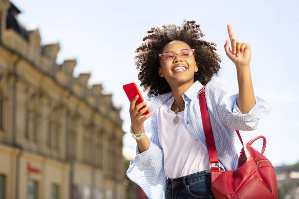 istock Cheerful curly woman asking to wait for her 996097146